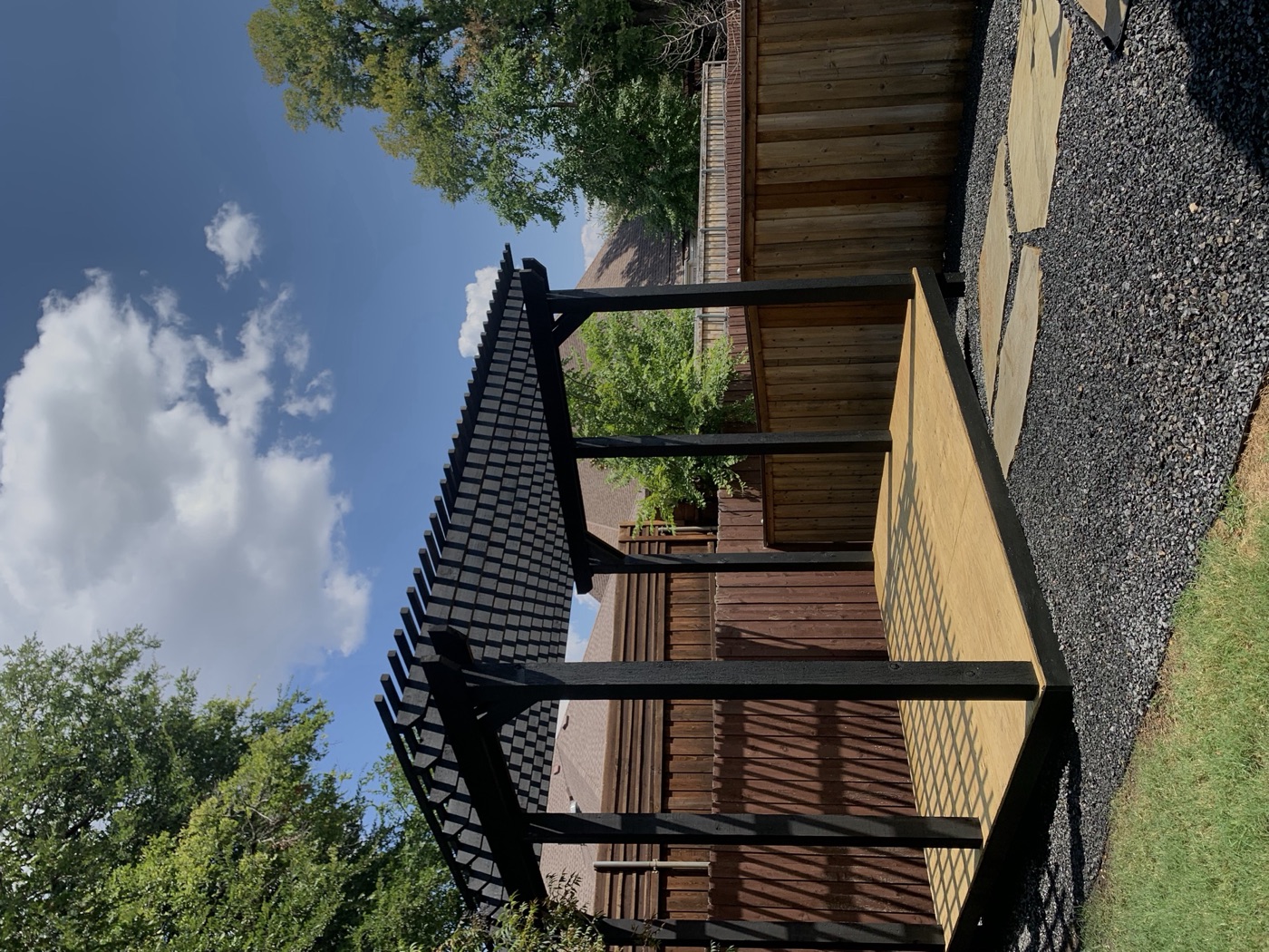 Custom cedar pergola over a backyard deck