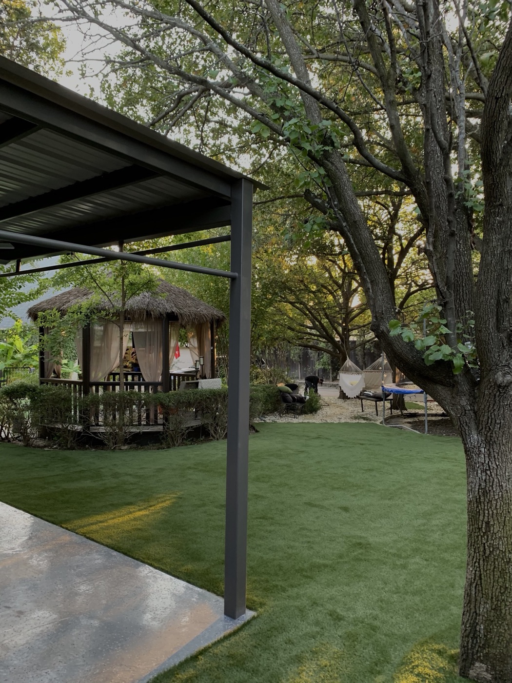 Backyard retreat with cabana and turf lawn