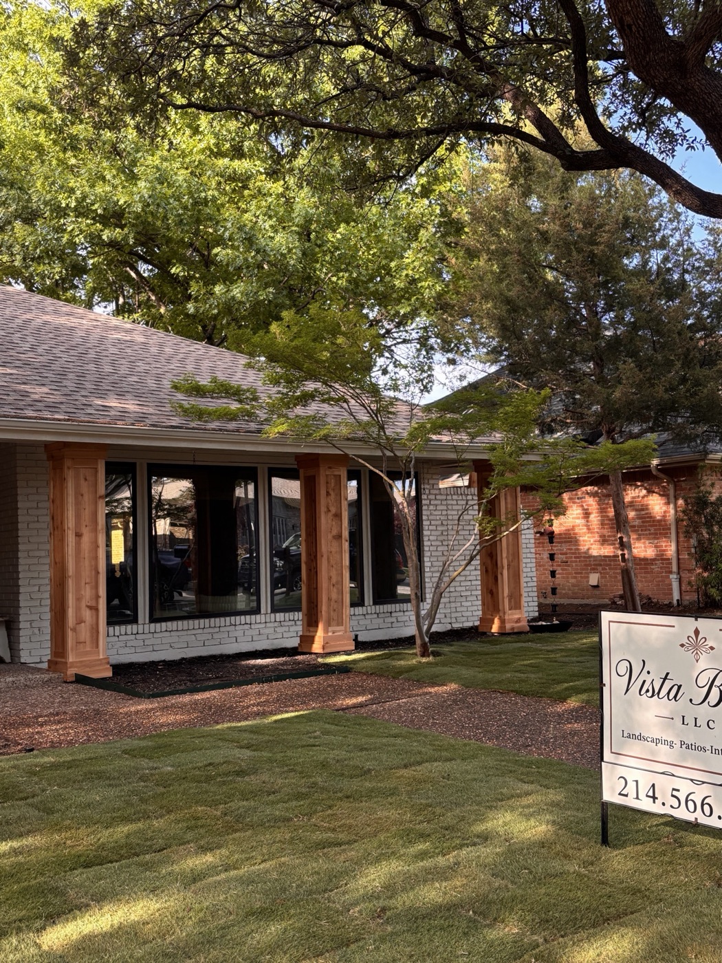 Home exterior with cedar-post pergola and stonework