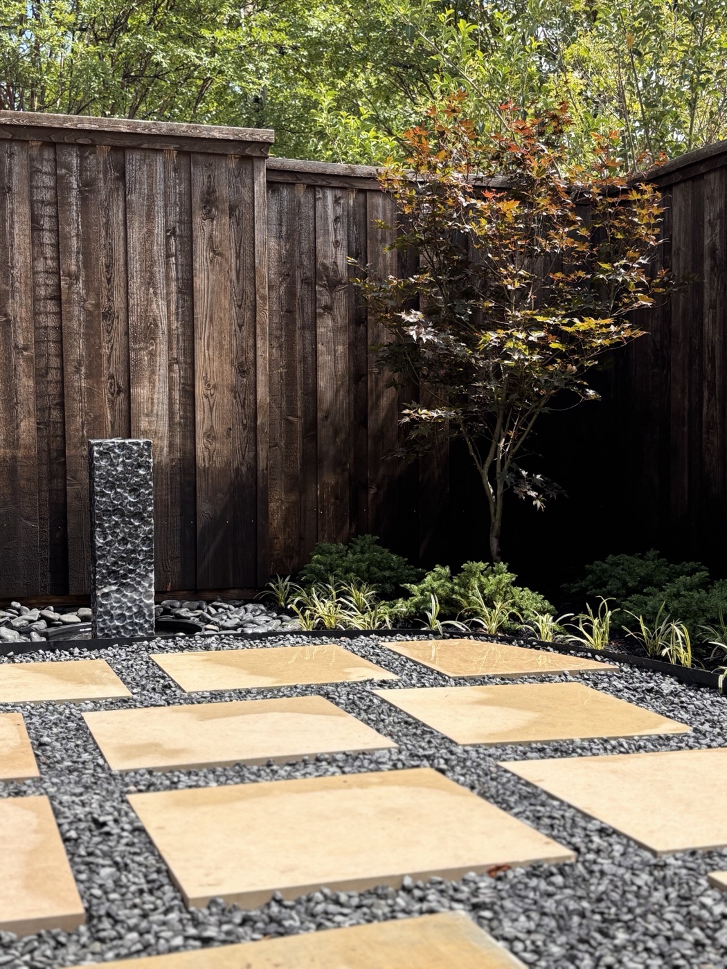 Flagstone stepping stones with a stacked-stone water feature